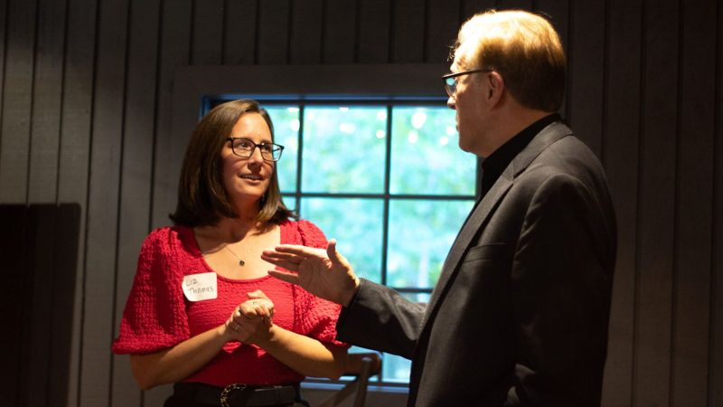 Rich Crawford performing strolling magic for a guest at a corporate networking event