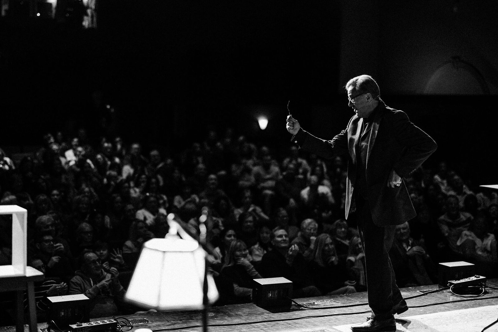 Rich Crawford performing a mentalism show on stage for a large corporate audience