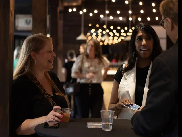 Guests laughing during strolling magic at an Atlanta event